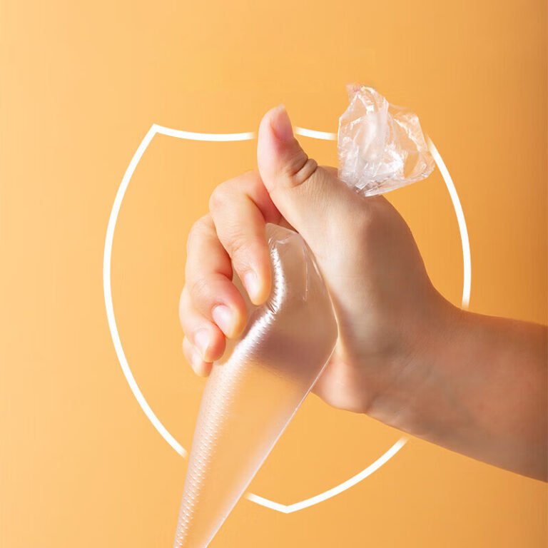 Hand squeezing a clear disposable piping bag