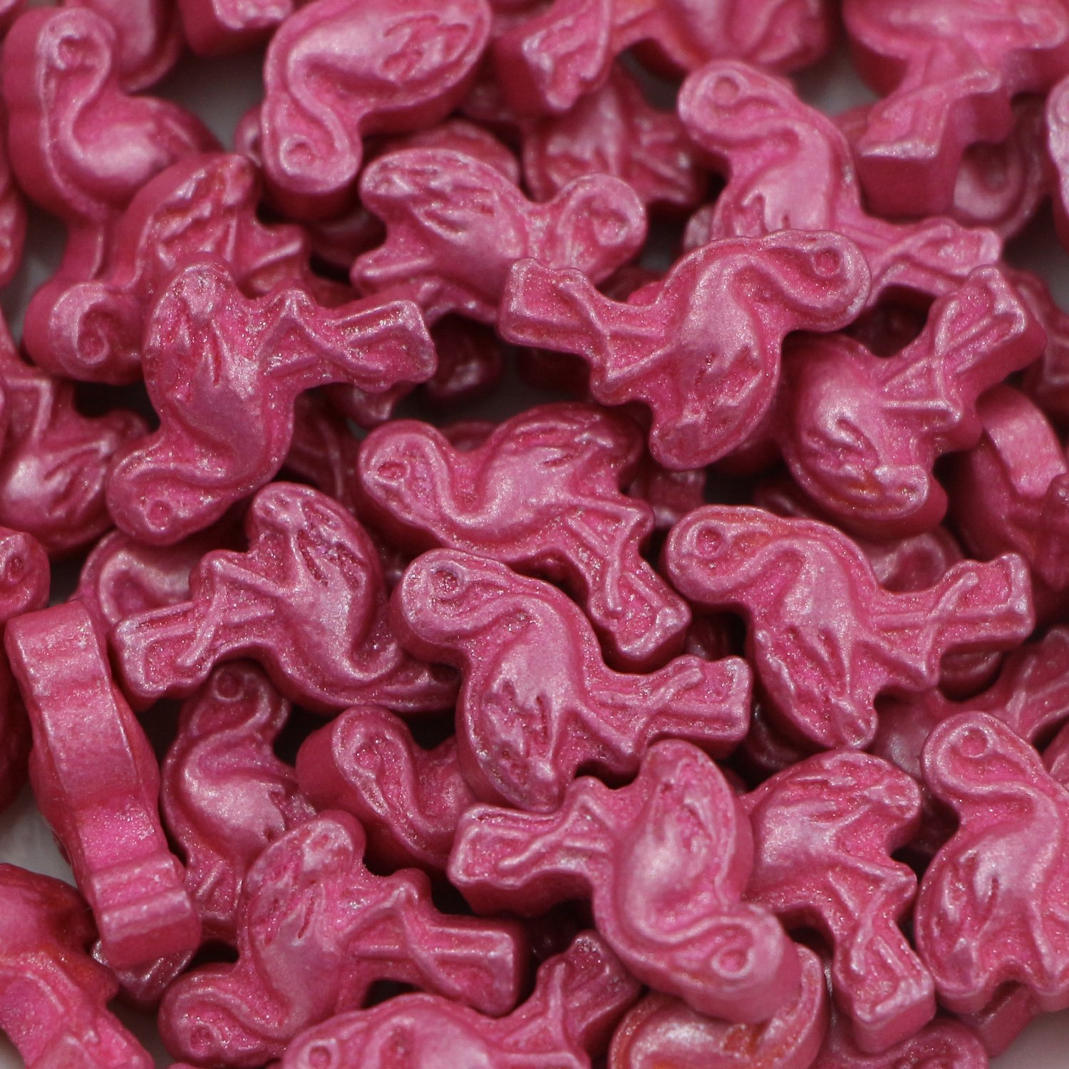 Pink flamingo-shaped press candy with fine embossed detail showing mould definition capability