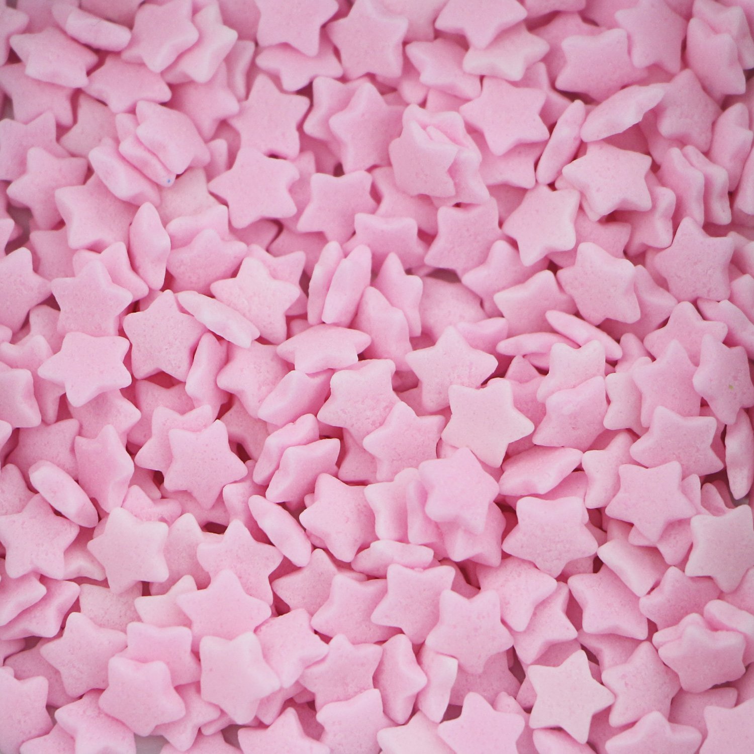 Pink star-shaped confetti sprinkles with clean defined points for seasonal bakery collections