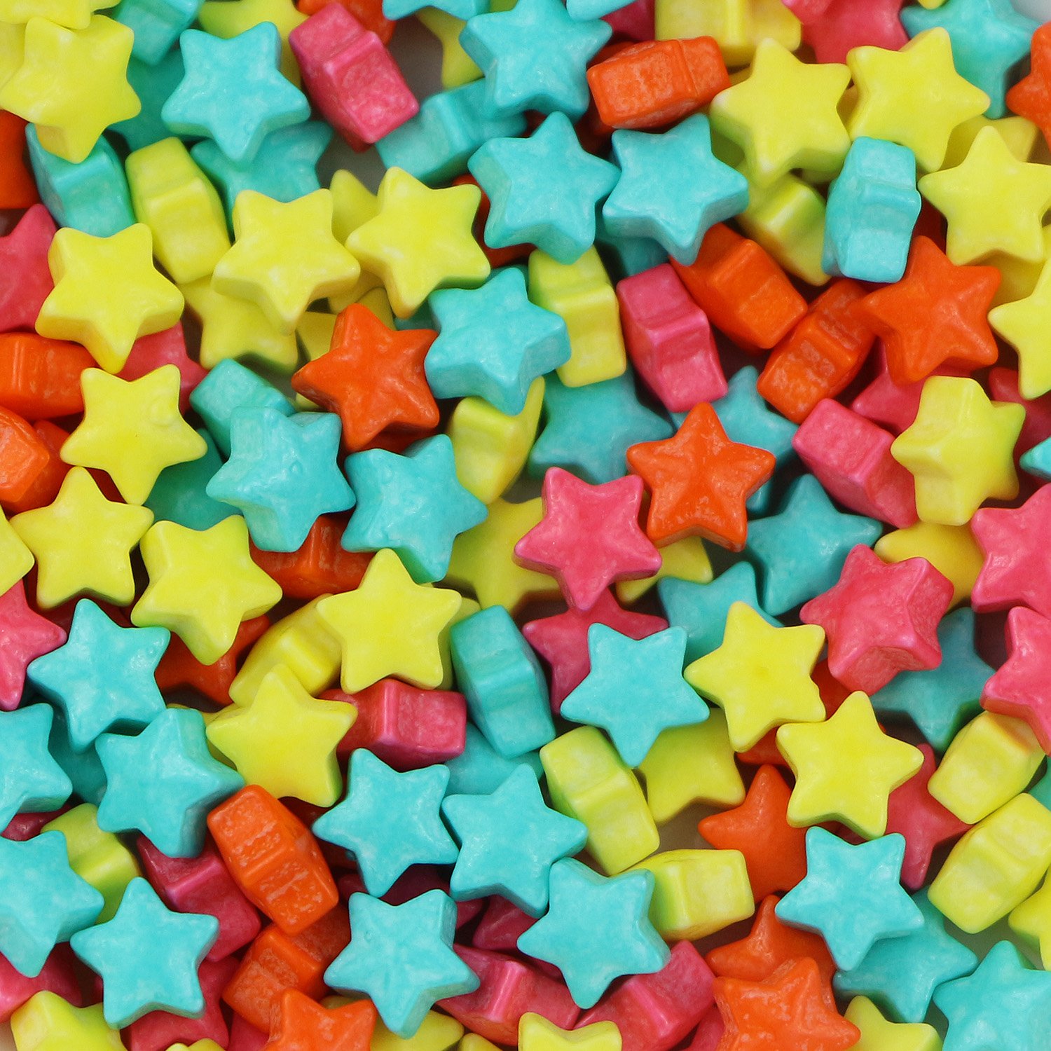 Multicoloured star-shaped press candy in yellow, turquoise, pink and orange for everyday bakery toppings