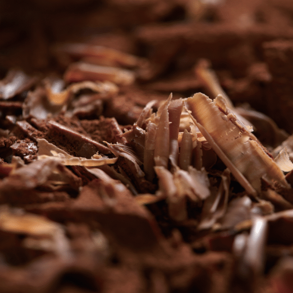 Fine chocolate shavings and curls dusted with cocoa