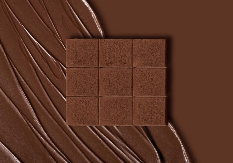 Milk chocolate tablet resting on a swirl of melted milk chocolate