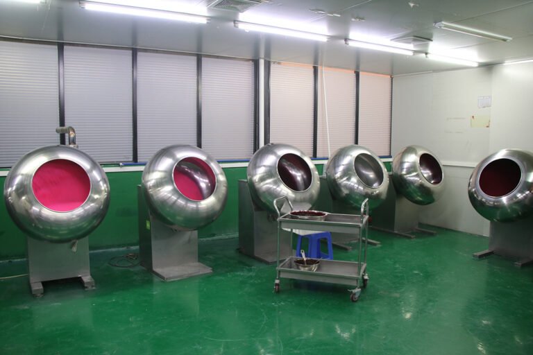 Sugar coating pans in the sprinkles factory