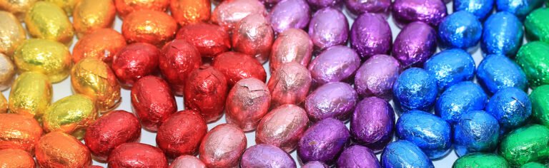 Rows of colourful foil-wrapped chocolate eggs