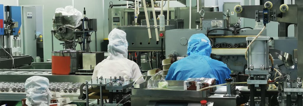 Confectionery production line with operators in hygiene suits and hairnets
