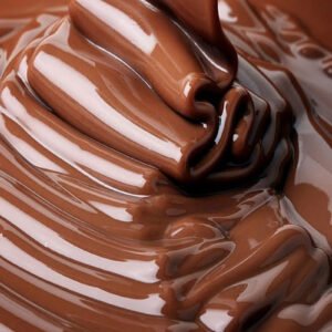 Melted milk chocolate coating flowing in glossy folds